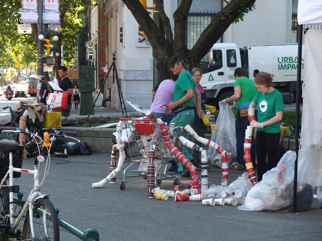 Volunteers use the coffee cups to create a sculpture.