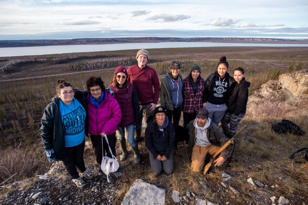 Emerging Leaders group posing for a photo on a rock in the north.