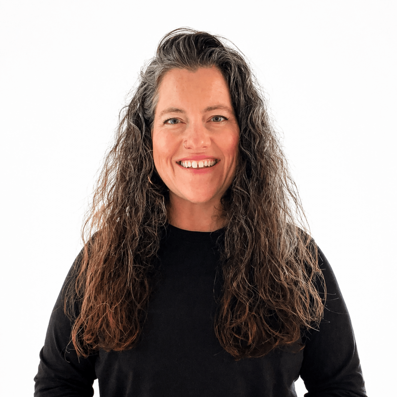 Erin Blanding is smiling and wearing a black crew neck sweater in front of a white background.