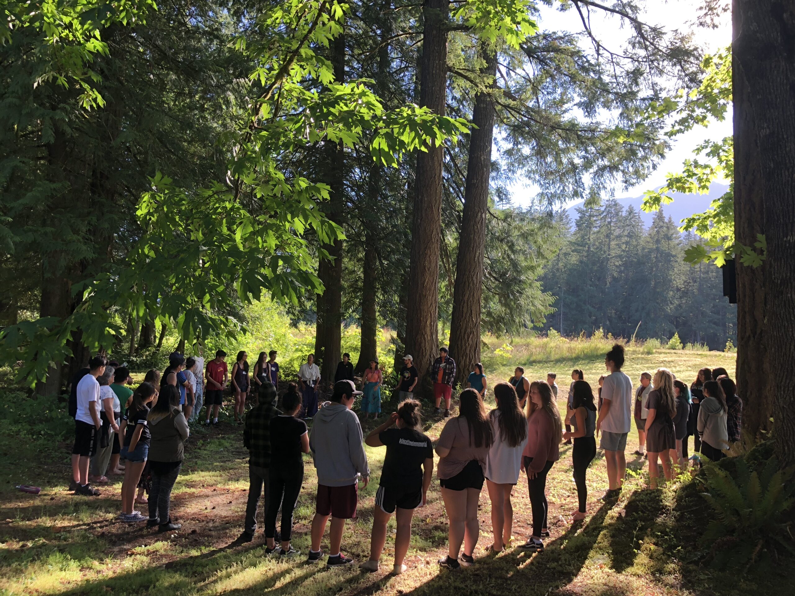 Participants gather in a circle during an IndigenEYEZ youth empowerment camp. 