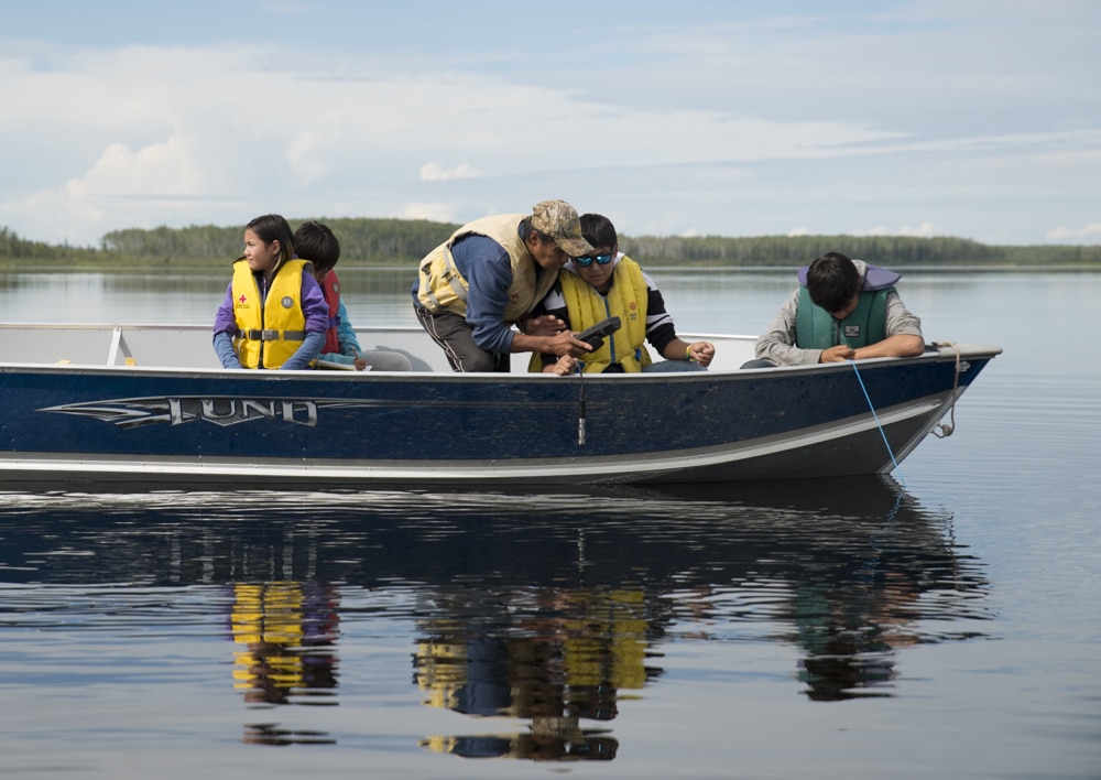 A group of men on a boat collecting data in Nunavut. Photo by Pat Kane