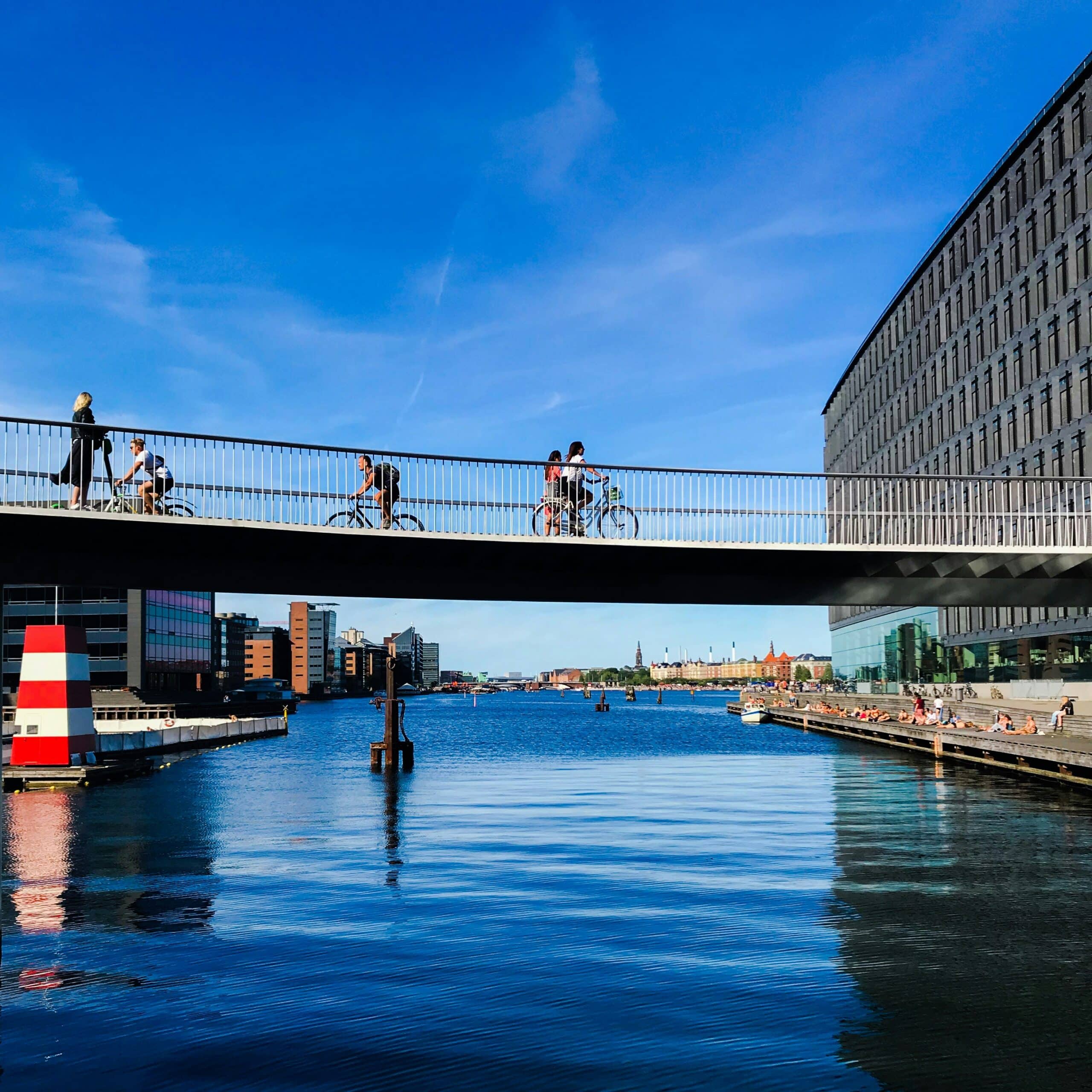 Pedestrians and cyclists on a bridge in urban space. Photo by Tolu Olarewaju