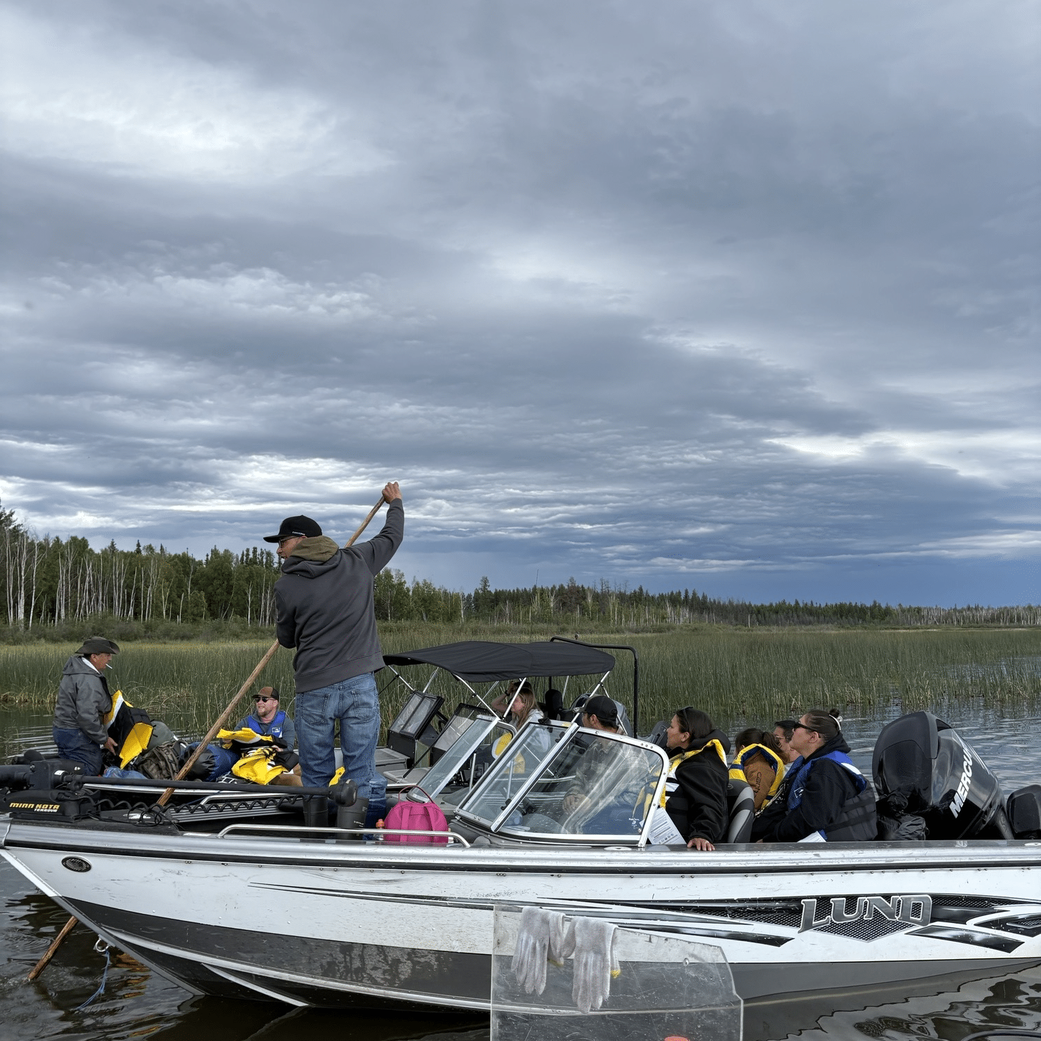 Attendees of the Sîhtoskâtowin Program-Gathering taking a boat ride on Frobisher Lake.