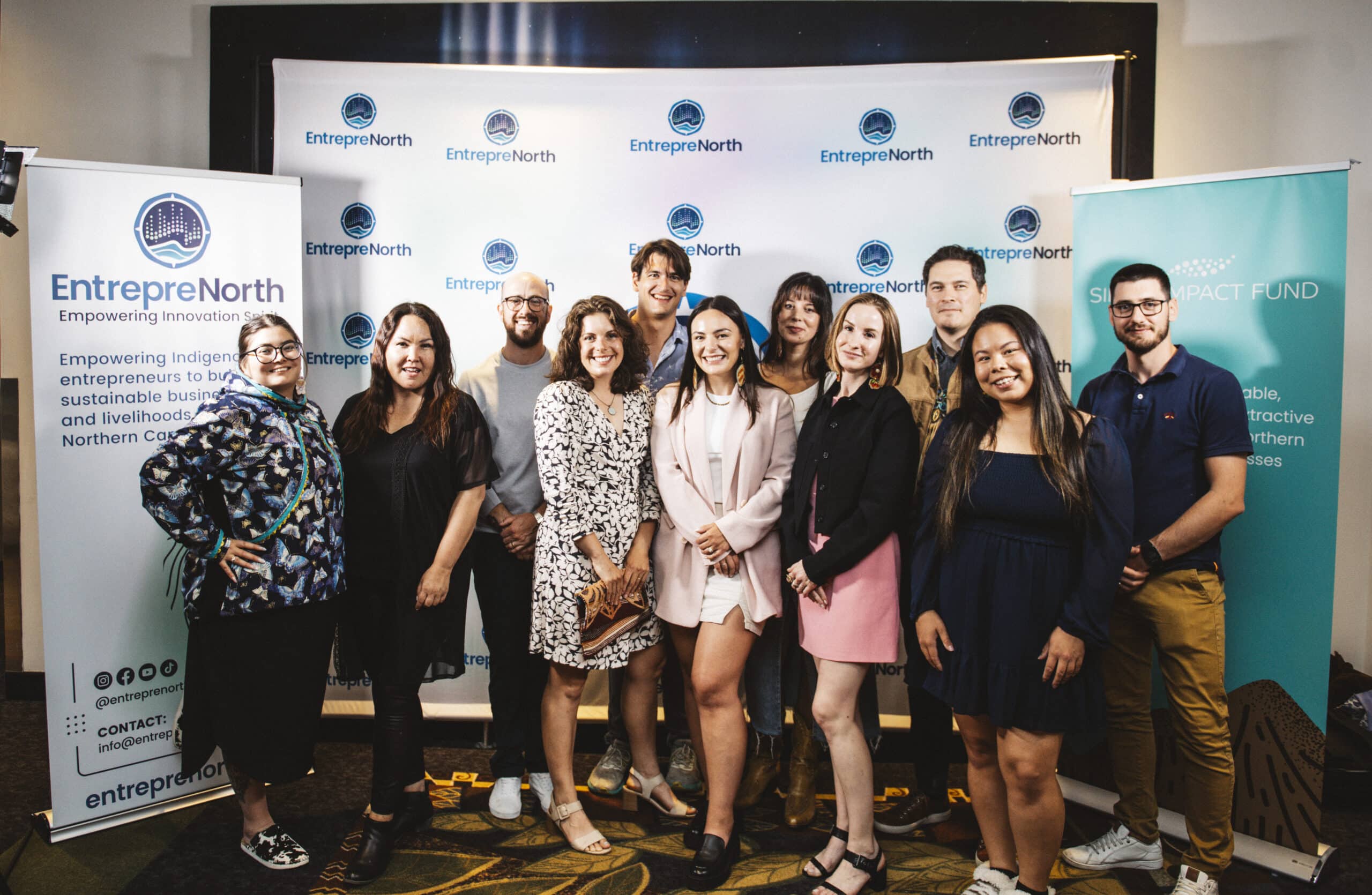 A group photo of the attendees at EntrepreNorth's Empowering Innovation Spirit Conference. They are standing in front of a conference banner, smiling and looking at the camera.