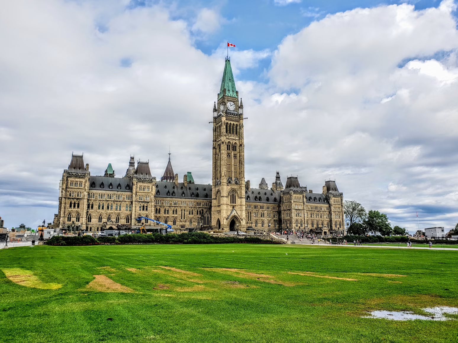 Aerial view of Parliament Hill in Ottawa, showing the Centre Block and Peace Tower overlooking the Ottawa River.